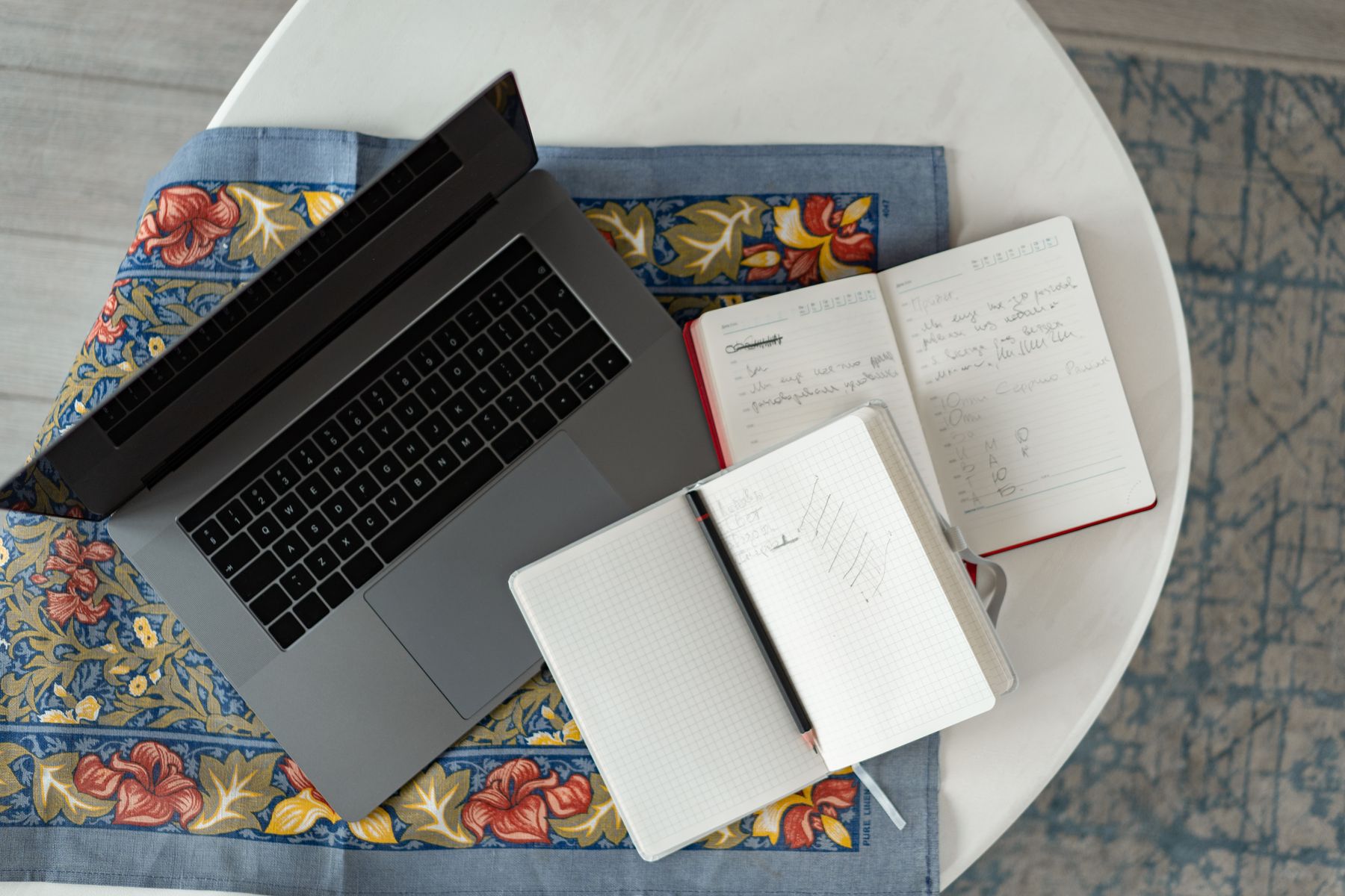 A laptop and notebook ready for essay writing